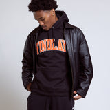 Person wearing a black hoodie with 'FINELAND' text and a leather jacket on a plain background
