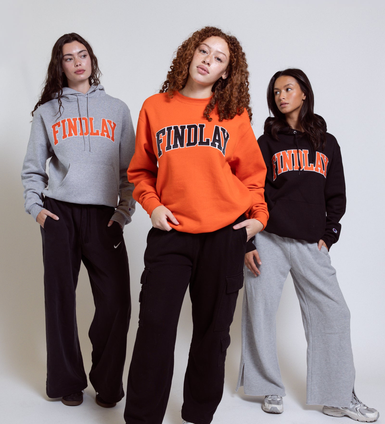 Three people wearing Findlay brand sweatshirts and pants on a white background