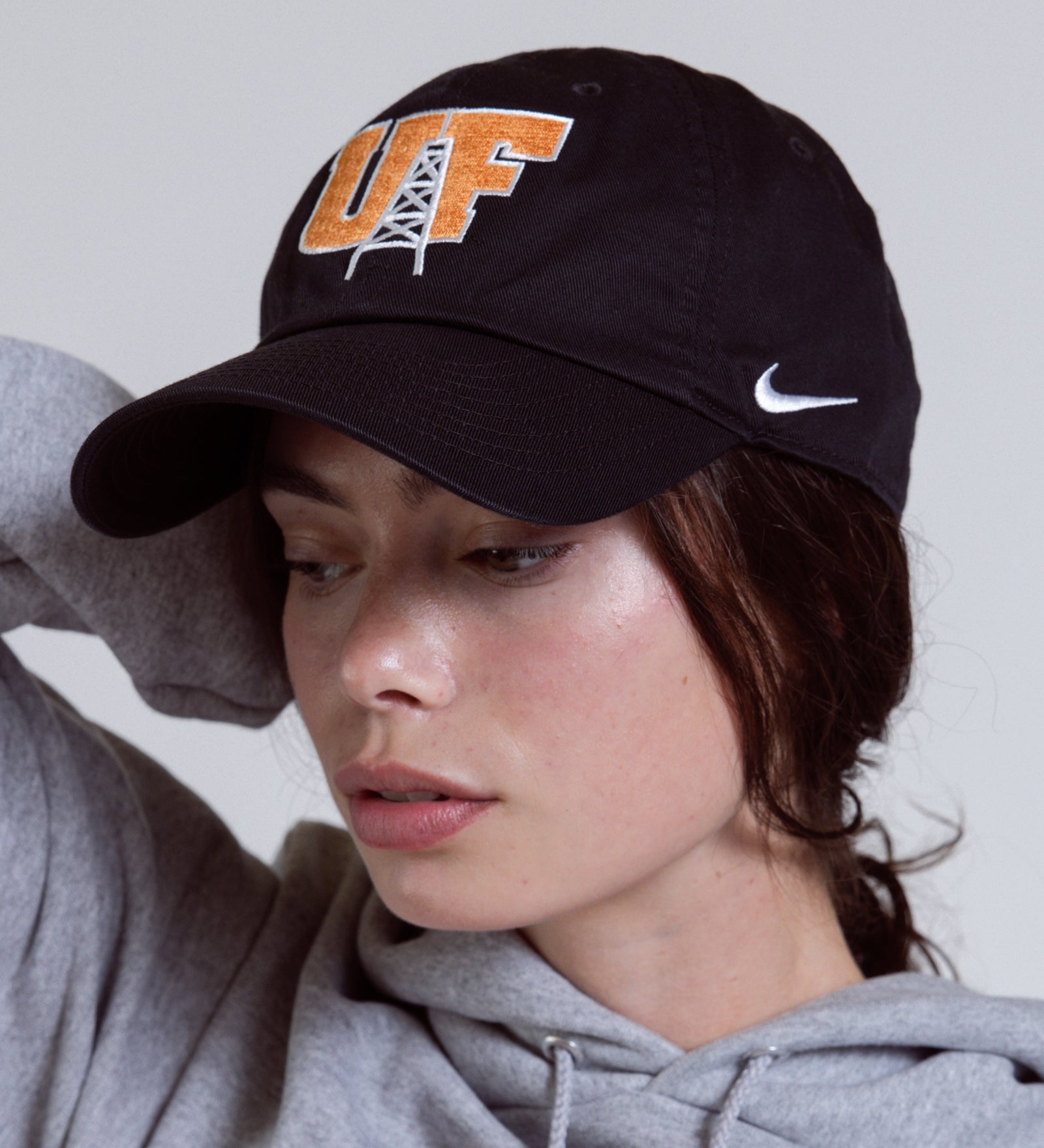 Person wearing a black cap with 'UF' and a gray hoodie with 'FINDLAY' text.