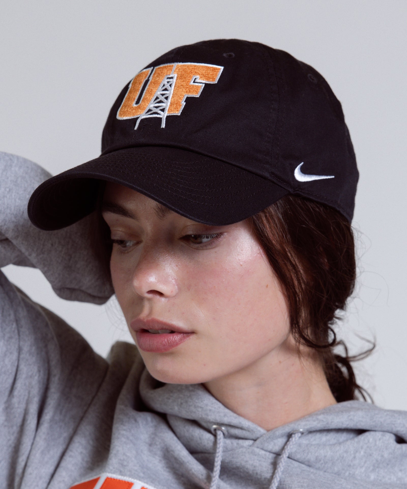 Person wearing a black cap with 'UF' and a gray hoodie with 'FINDLAY' text.